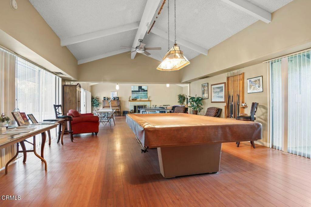 1273 South Rice Road, Unit 53 Ojai, CA 93023 - Photo 33 of 42 a living room with furniture a wooden floor and a chandelier