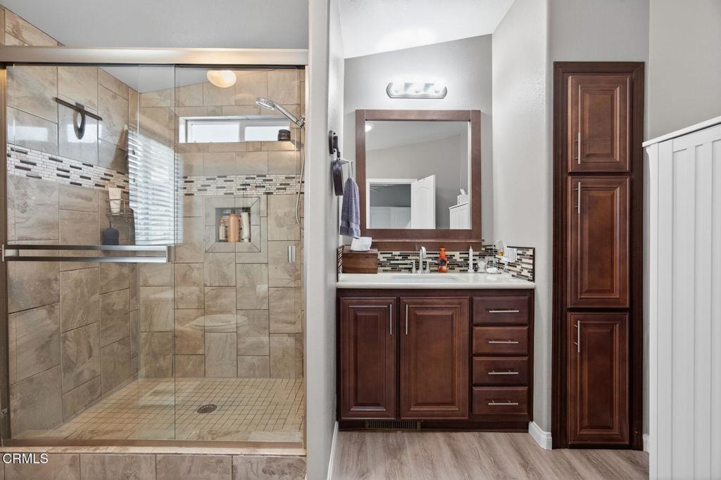 1273 South Rice Road, Unit 53 Ojai, CA 93023 - Photo 4 of 42 a bathroom with a granite countertop sink a mirror and a shower