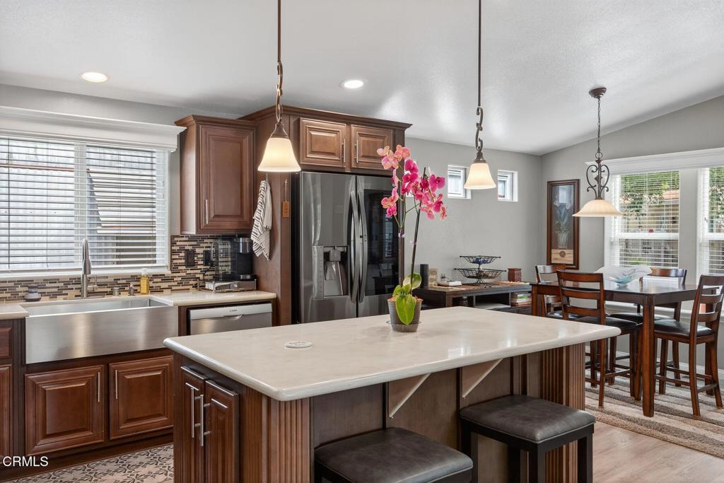 1273 South Rice Road, Unit 53 Ojai, CA 93023 - Photo 7 of 42 a kitchen with a table chairs and stove
