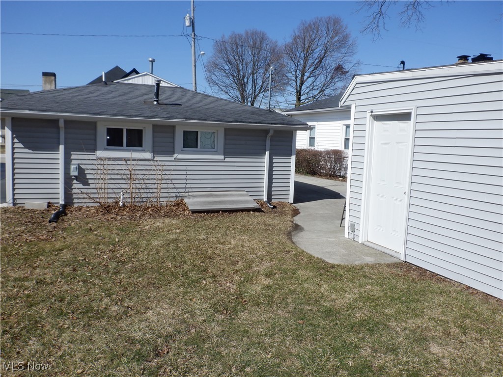 38376 Beachview Road Willoughby, OH 44094 - Photo 4 of 10 Back of property featuring a lawn and roof with shingles