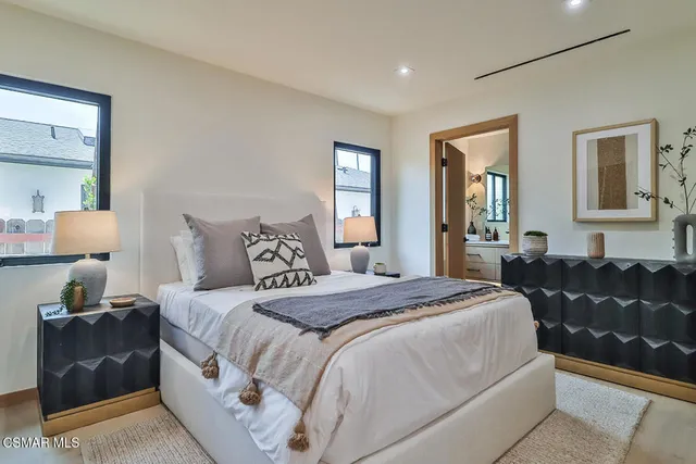 a bedroom with a bed and a painting on the wall