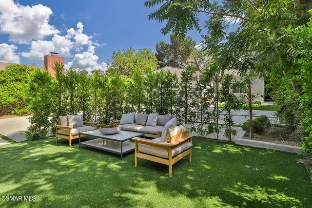 a view of a dining room with furniture and a potted plant