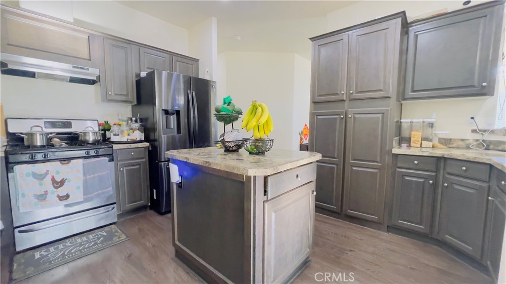 2139 East 4th Street, Unit 142 Ontario, CA 91764 - Photo 13 of 34 a kitchen with stainless steel appliances granite countertop a stove a refrigerator and a refrigerator