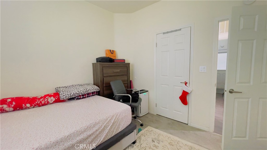 2139 East 4th Street, Unit 142 Ontario, CA 91764 - Photo 17 of 34 a bedroom with a bed and cabinets