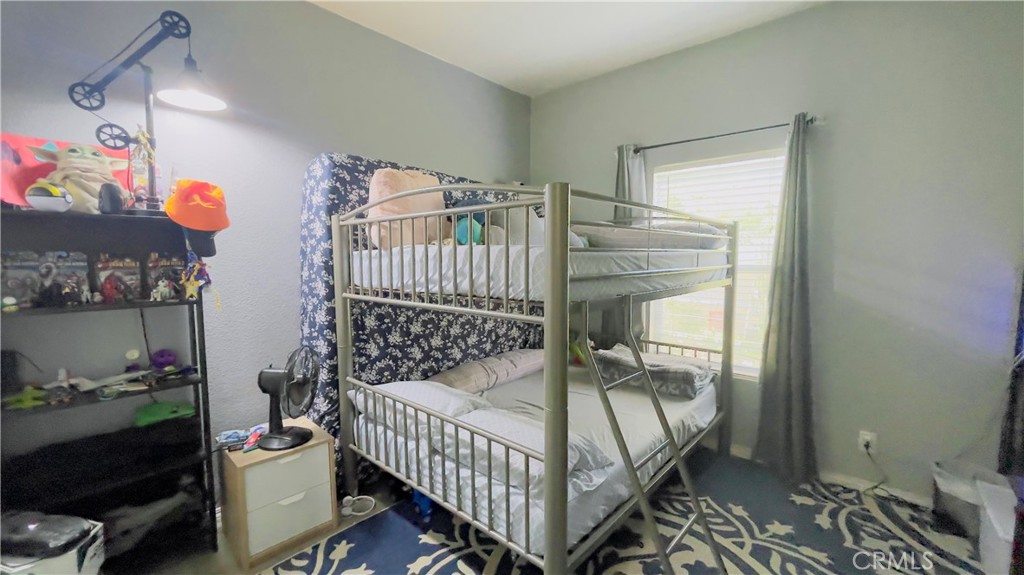 2139 East 4th Street, Unit 142 Ontario, CA 91764 - Photo 19 of 34 a bedroom with a bed and a window