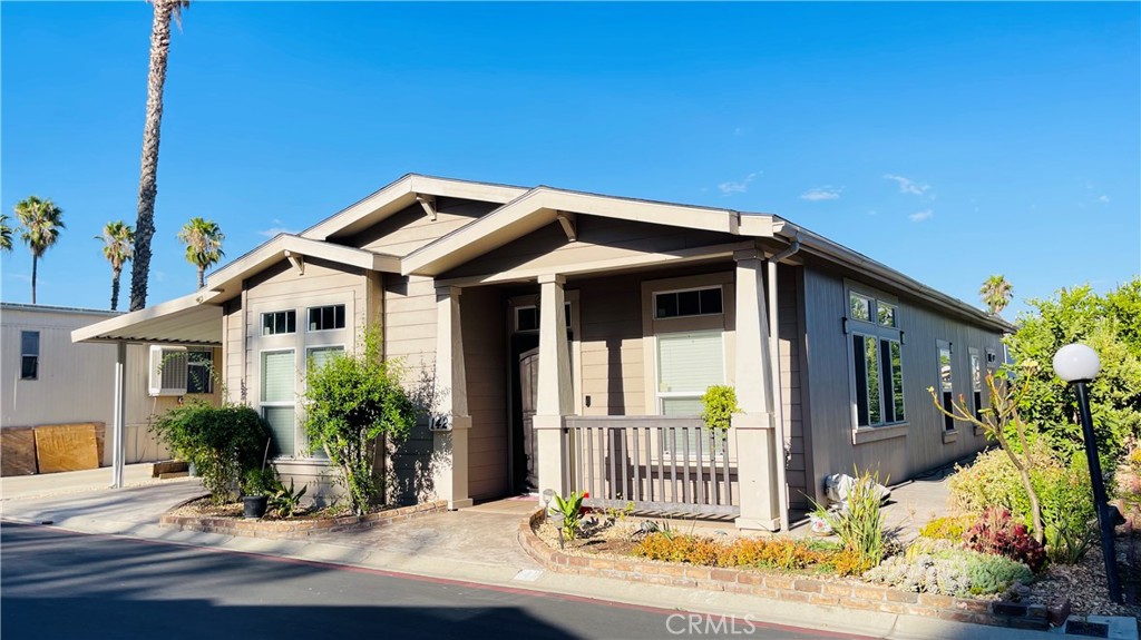 2139 East 4th Street, Unit 142 Ontario, CA 91764 - Photo 2 of 34 a front view of a house with a porch