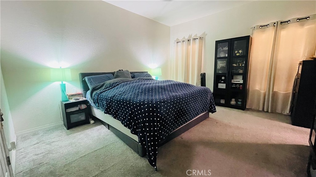 2139 East 4th Street, Unit 142 Ontario, CA 91764 - Photo 22 of 34 a bedroom with a bed window and a walk in closet