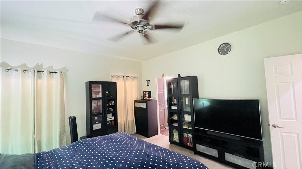 2139 East 4th Street, Unit 142 Ontario, CA 91764 - Photo 23 of 34 a bedroom with a bed and a flat tv screen on dresser