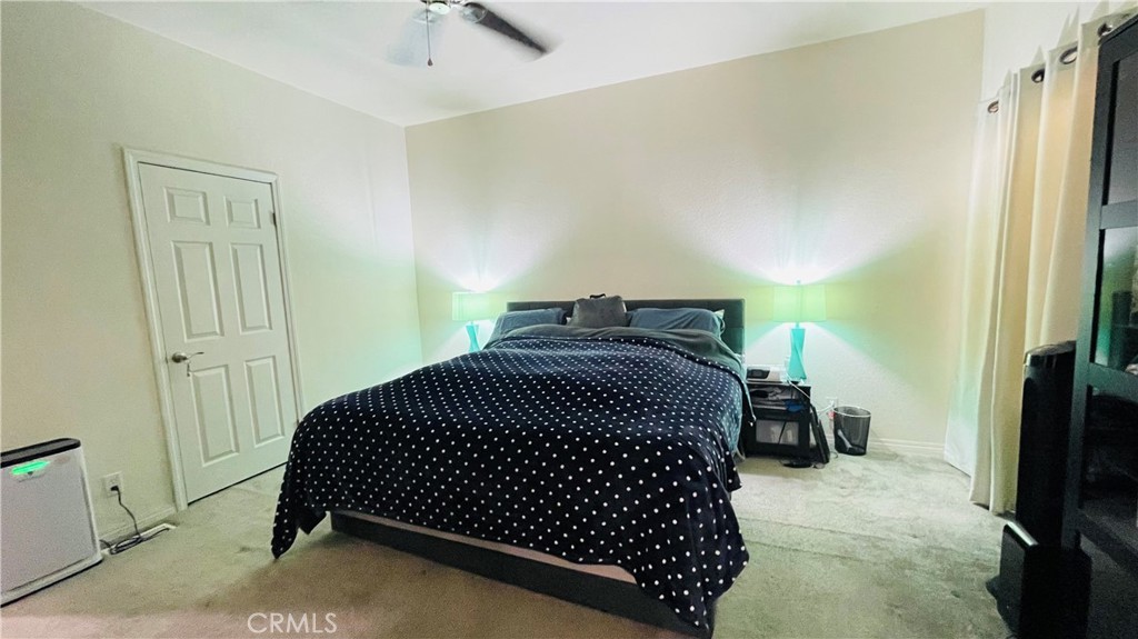 2139 East 4th Street, Unit 142 Ontario, CA 91764 - Photo 24 of 34 a bedroom with a bed and chair