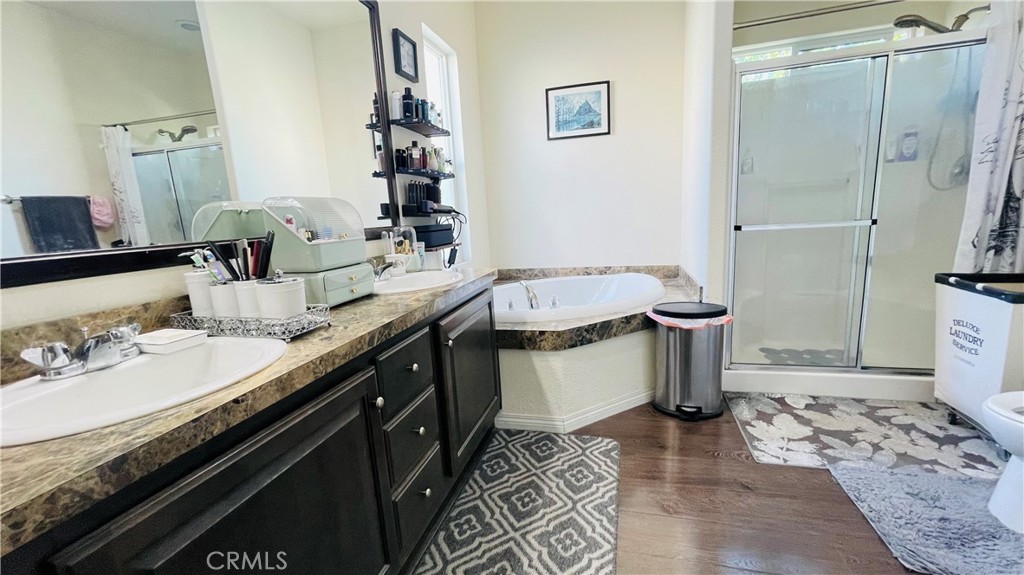 2139 East 4th Street, Unit 142 Ontario, CA 91764 - Photo 26 of 34 a spacious bathroom with a granite countertop sink and a mirror