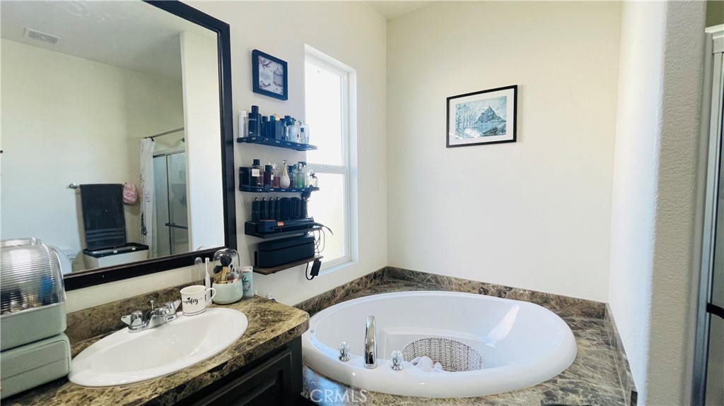 2139 East 4th Street, Unit 142 Ontario, CA 91764 - Photo 29 of 34 a bathroom with a sink and a mirror