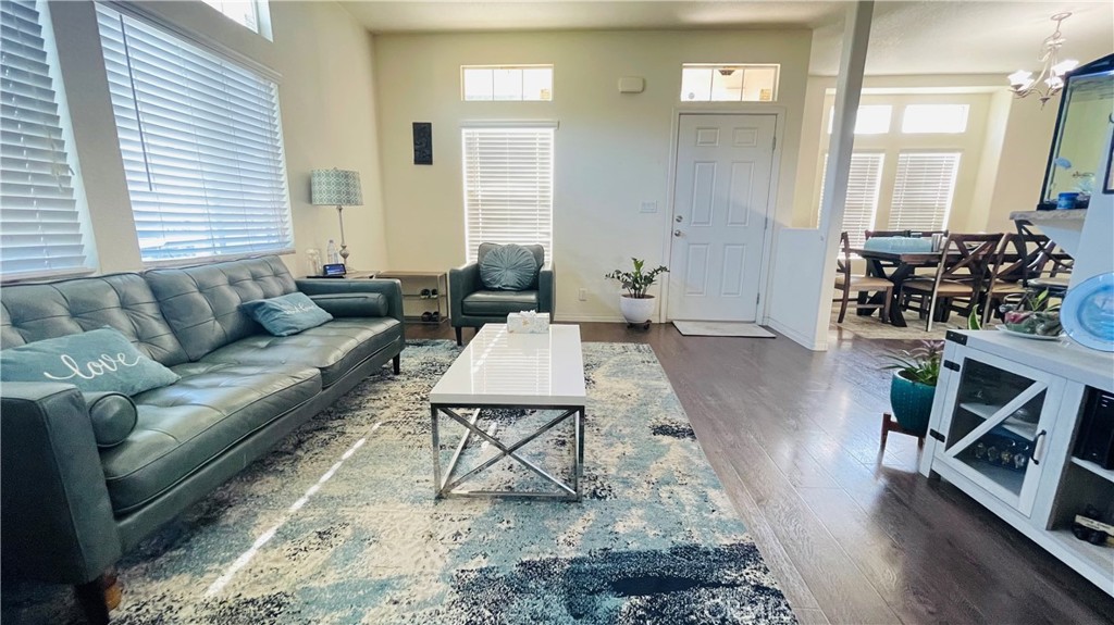 2139 East 4th Street, Unit 142 Ontario, CA 91764 - Photo 7 of 34 a living room with furniture wooden floor and a fireplace