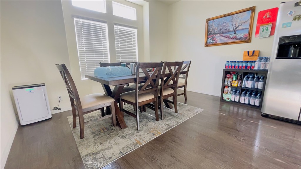 2139 East 4th Street, Unit 142 Ontario, CA 91764 - Photo 10 of 34 a view of a dining room with furniture and a book shelf