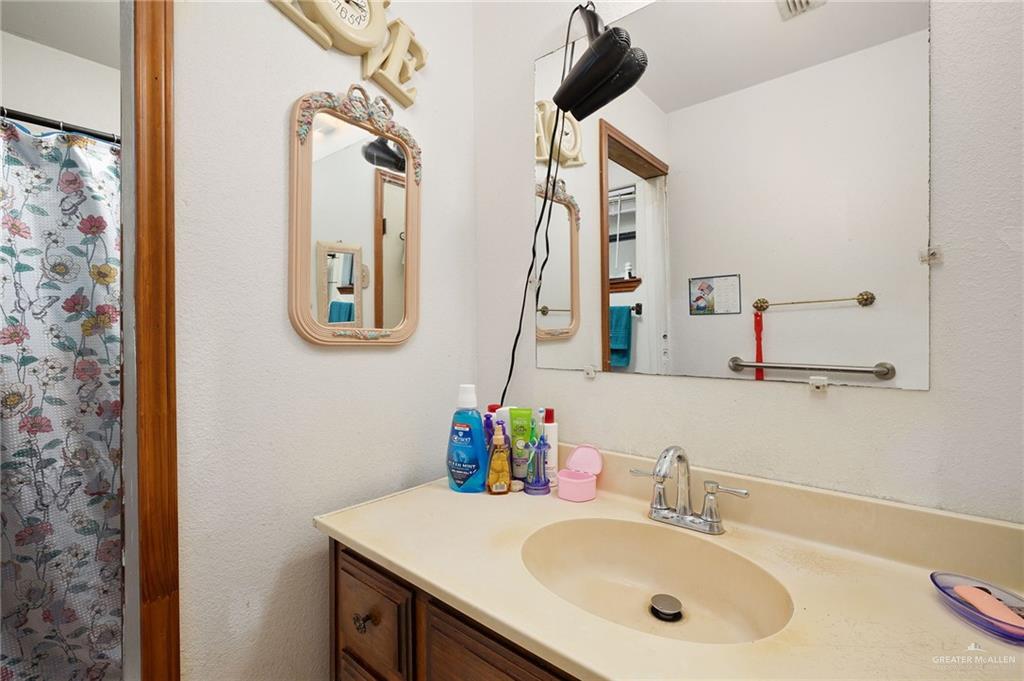 6610 West Mile 2 Road Mission, TX 78574 - Photo 11 of 18 a bathroom with a sink and a mirror