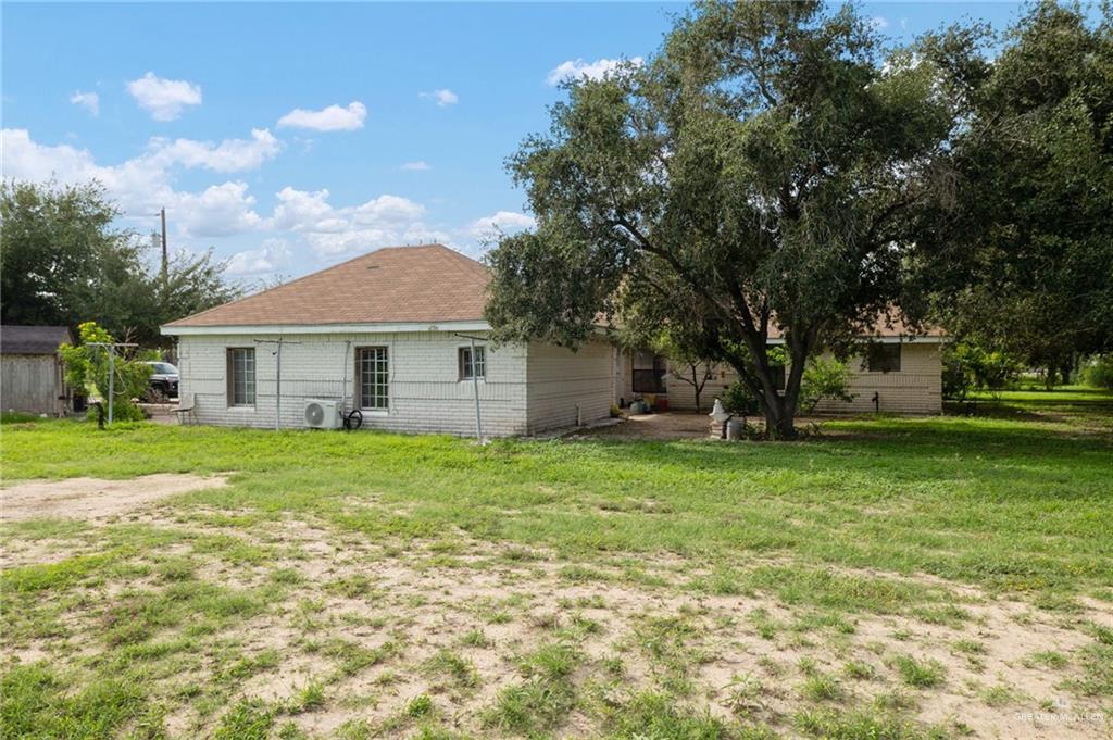 6610 West Mile 2 Road Mission, TX 78574 - Photo 16 of 18 a backyard of a house with plants and large tree