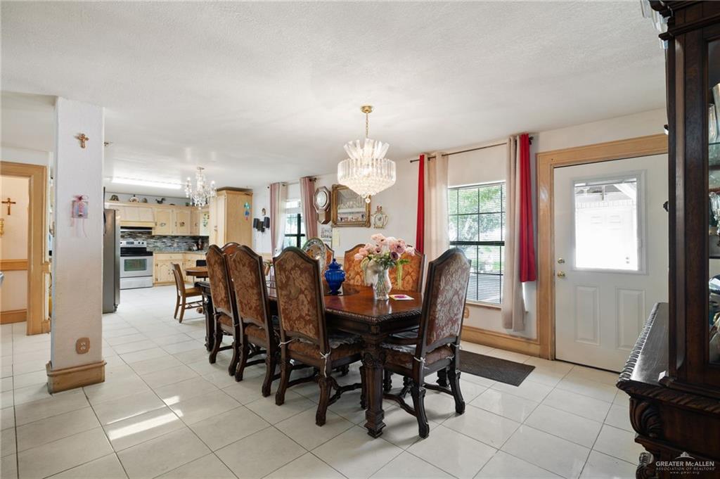 6610 West Mile 2 Road Mission, TX 78574 - Photo 5 of 18 a view of a dining room with furniture and a chandelier