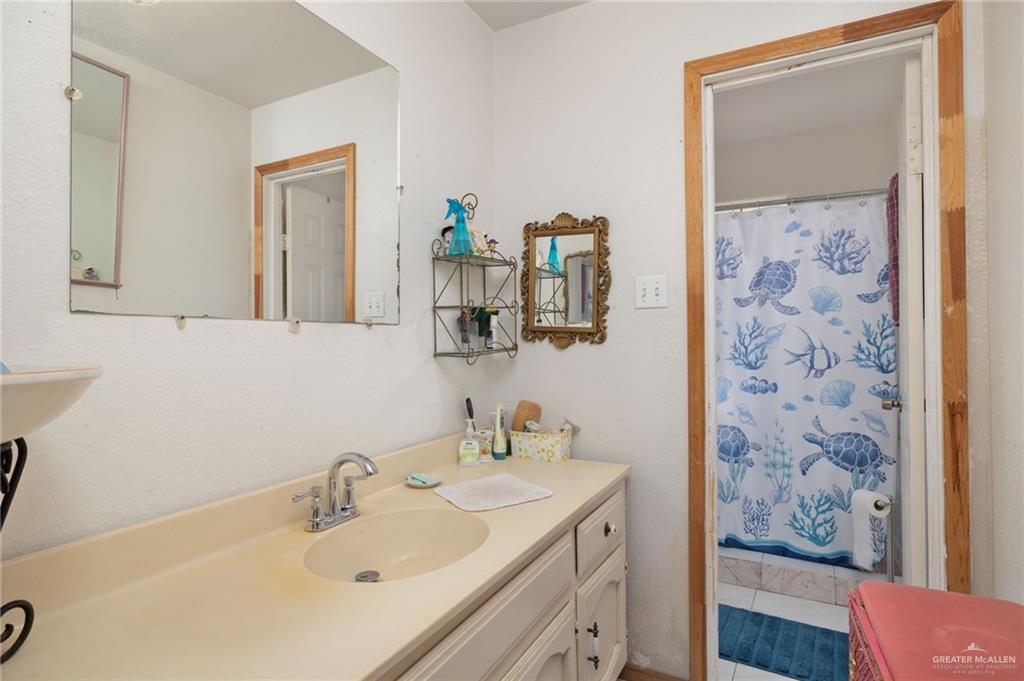6610 West Mile 2 Road Mission, TX 78574 - Photo 9 of 18 a bathroom with a sink and a mirror