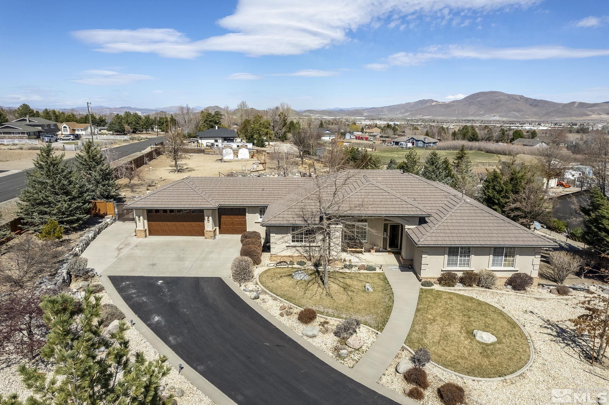 aerial view of a house with swimming pool and mountains