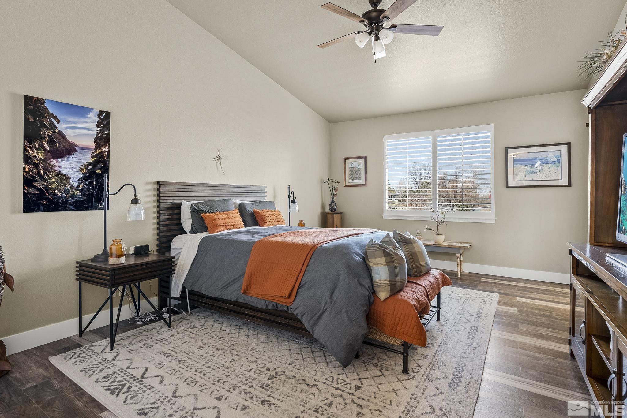 735 Flanders Road Reno, NV 89511 - Photo 20 of 40 a bedroom with a bed and wooden floor