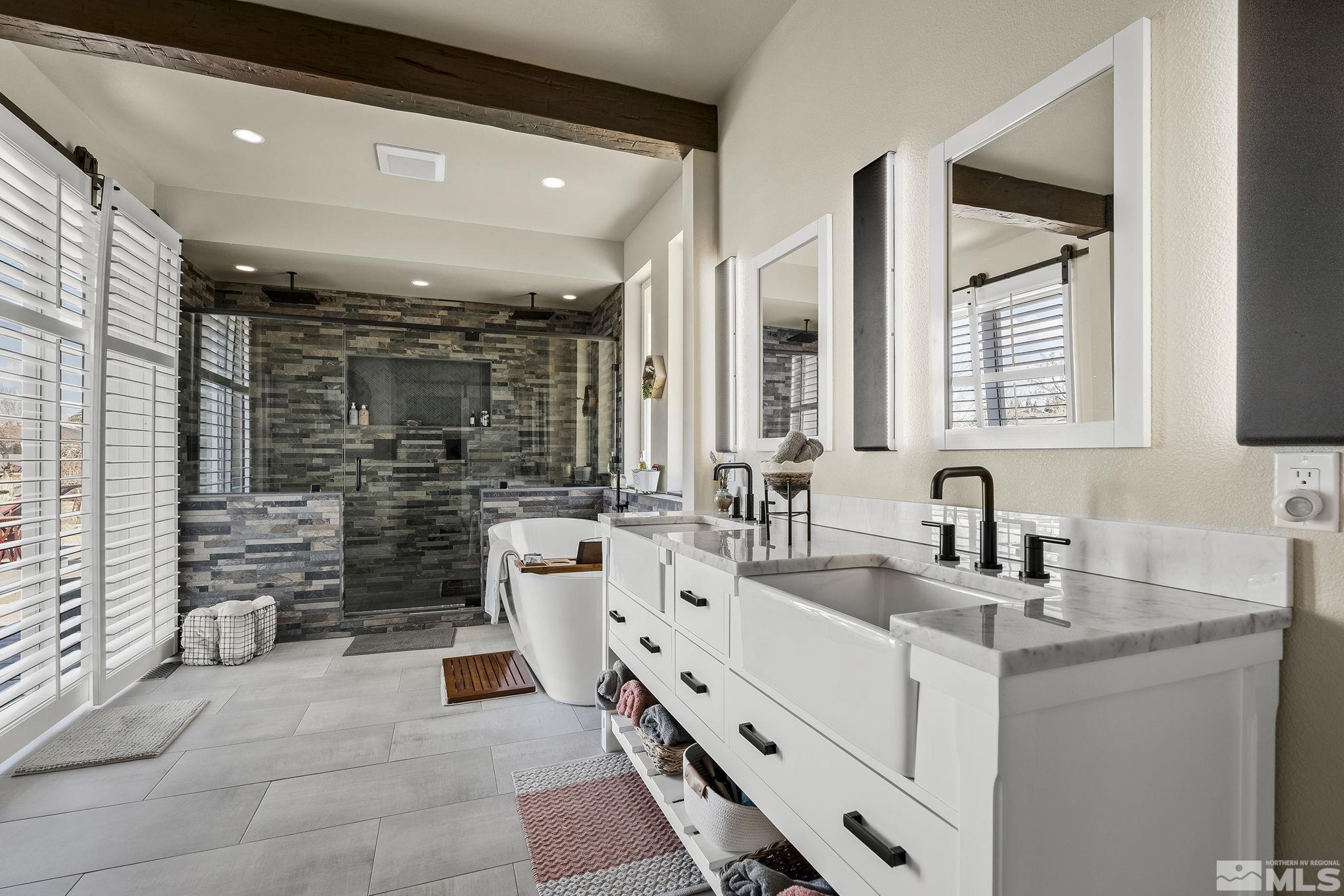 735 Flanders Road Reno, NV 89511 - Photo 22 of 40 a bathroom with a double vanity sink a mirror and a shower