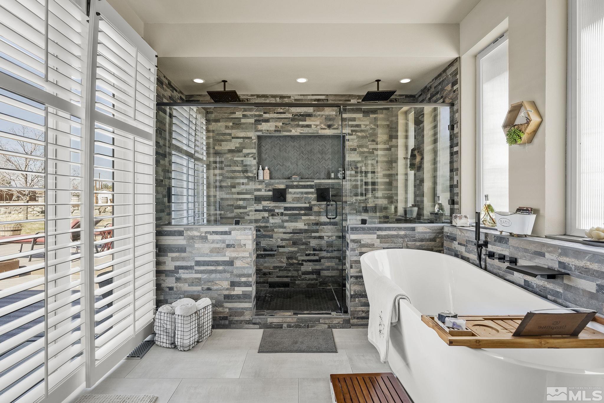 735 Flanders Road Reno, NV 89511 - Photo 23 of 40 a bathroom with a bathtub and a shower