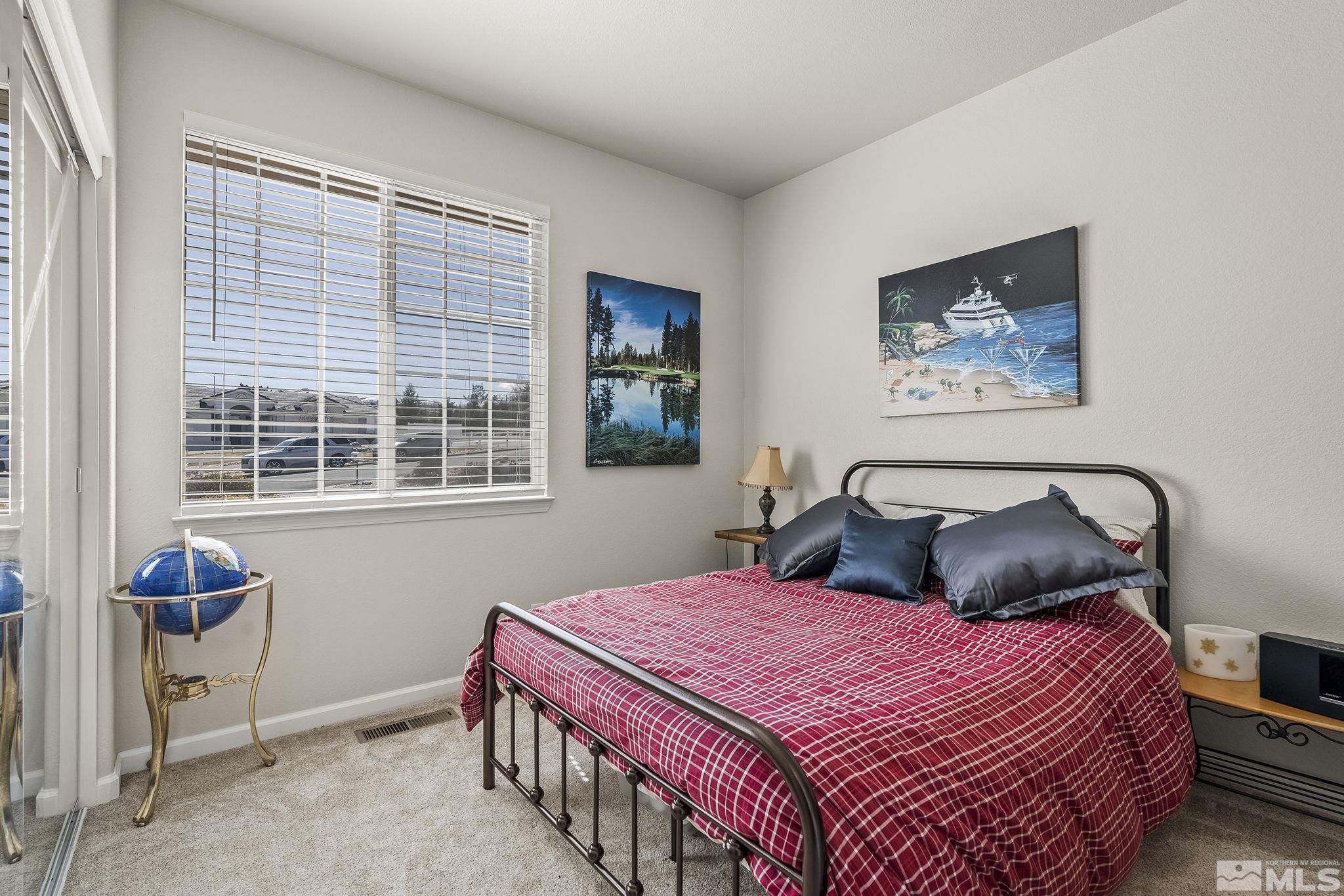 735 Flanders Road Reno, NV 89511 - Photo 25 of 40 a bedroom with a bed and a window