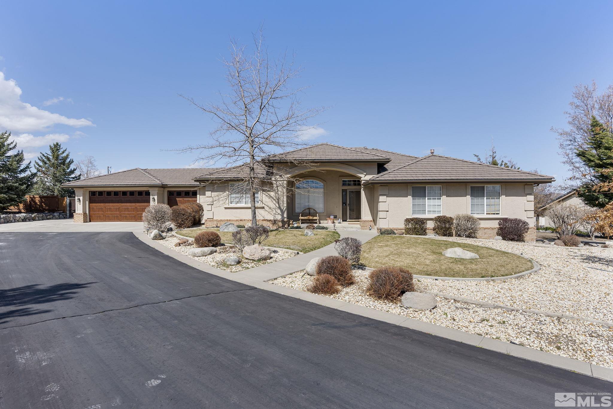735 Flanders Road Reno, NV 89511 - Photo 4 of 40 a front view of a house with yard and seating space