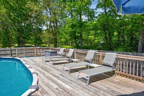 a view of a patio with chairs and plants