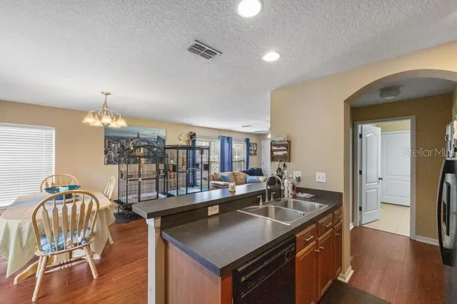 a kitchen with counter top space a sink and cabinets