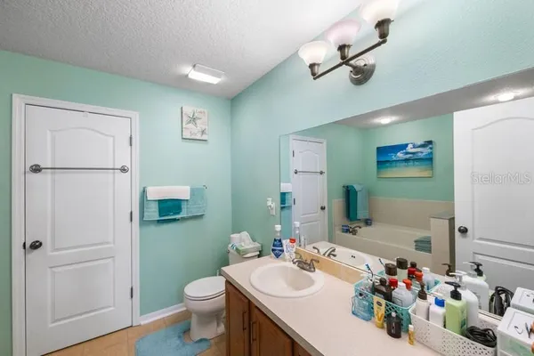 a bathroom with a sink vanity mirror and toilet