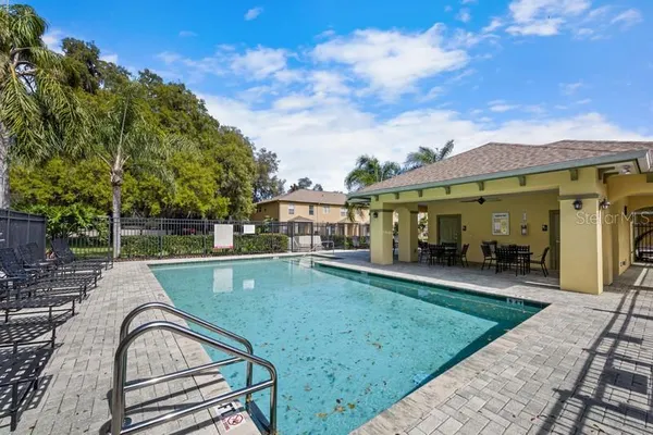 a view of a house with a swimming pool and sitting area