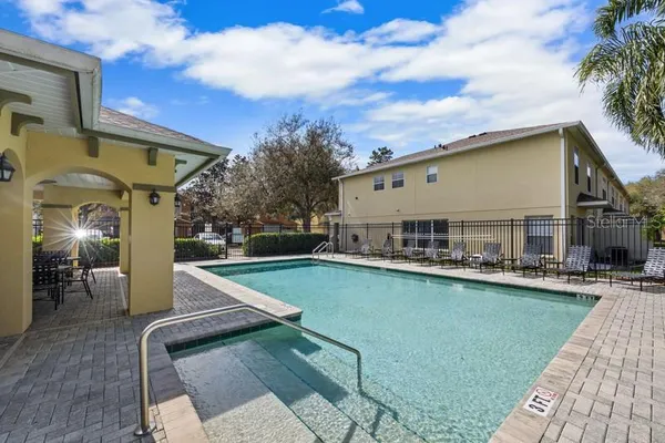 a view of a patio with swimming pool table and chairs