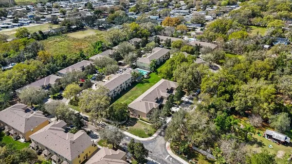 an aerial view of residential houses with outdoor space