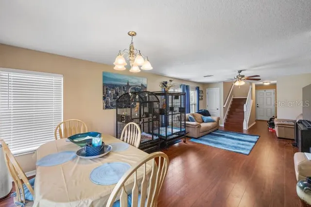 a view of a dining room with furniture wooden floor and chandelier