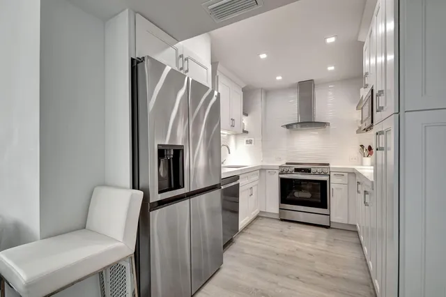 a kitchen with a refrigerator and a sink