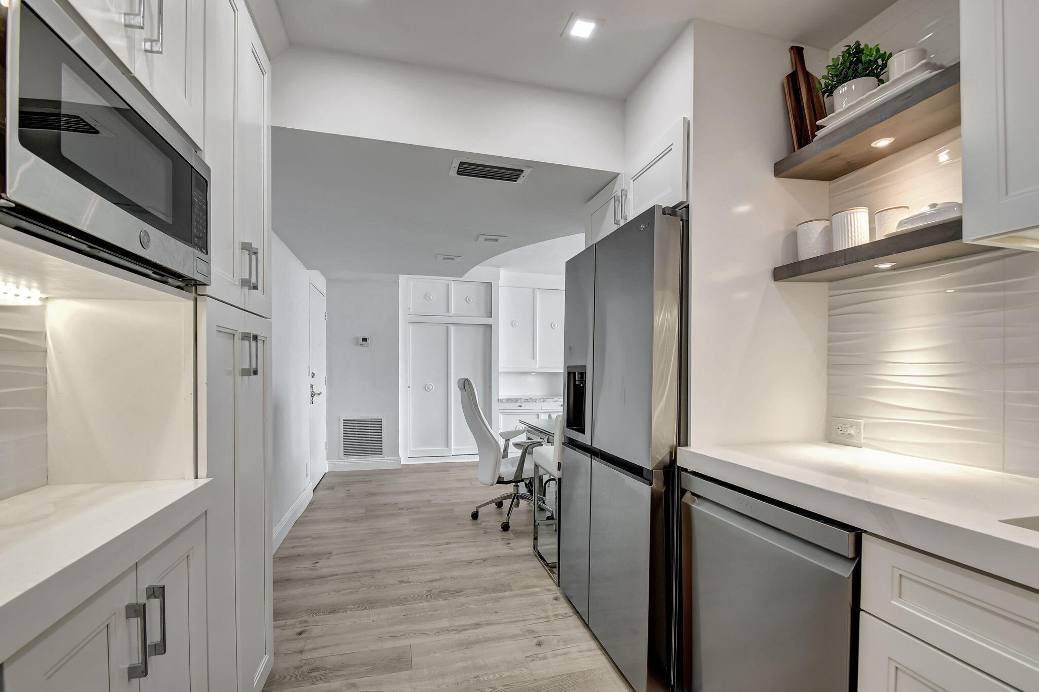 2840 South Ocean Boulevard, Unit 3020 Palm Beach, FL 33480 - Photo 15 of 40 a view of a hallway with wooden floor and staircase