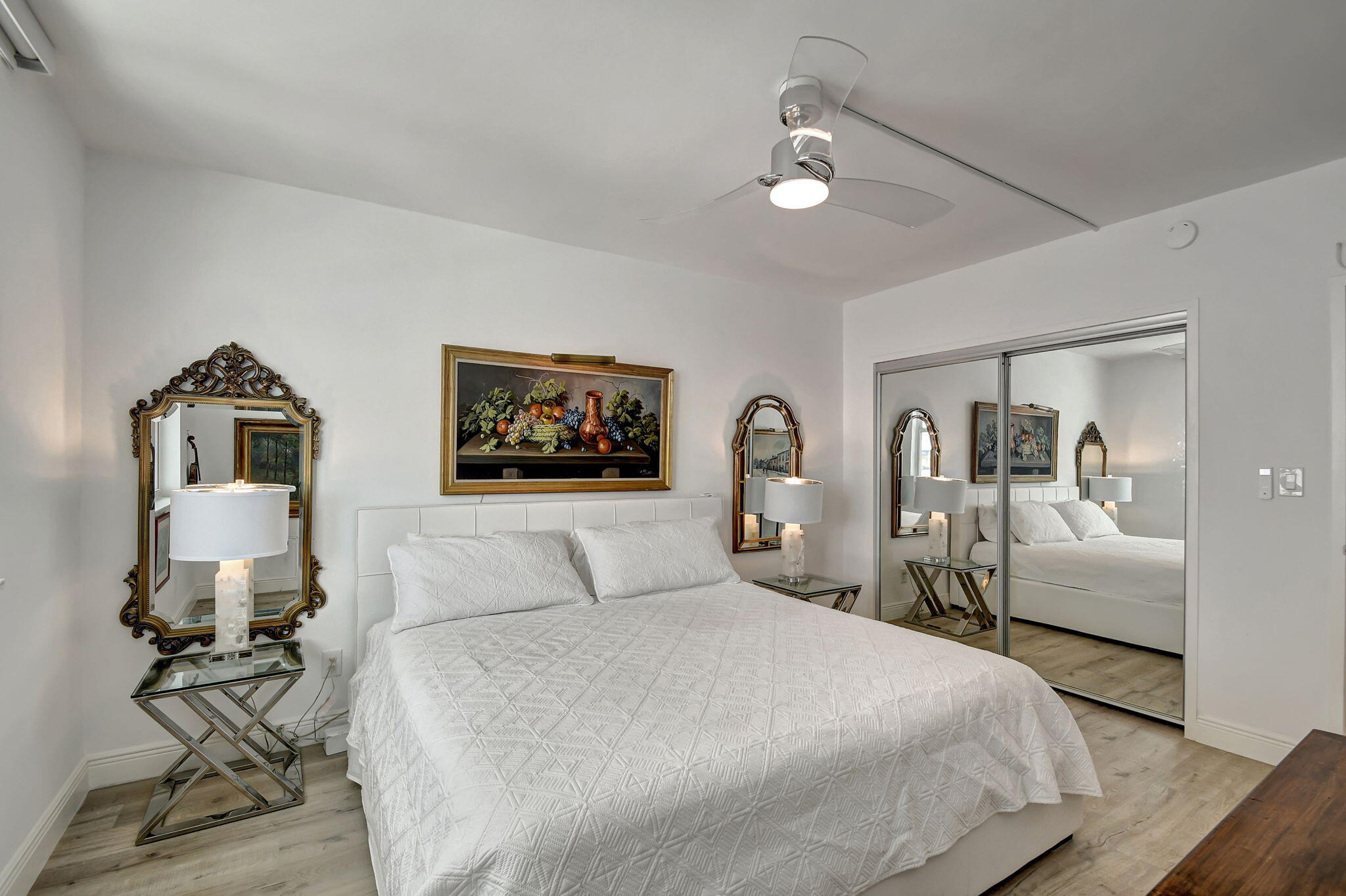 2840 South Ocean Boulevard, Unit 3020 Palm Beach, FL 33480 - Photo 16 of 40 a bedroom with a large bed and a chandelier