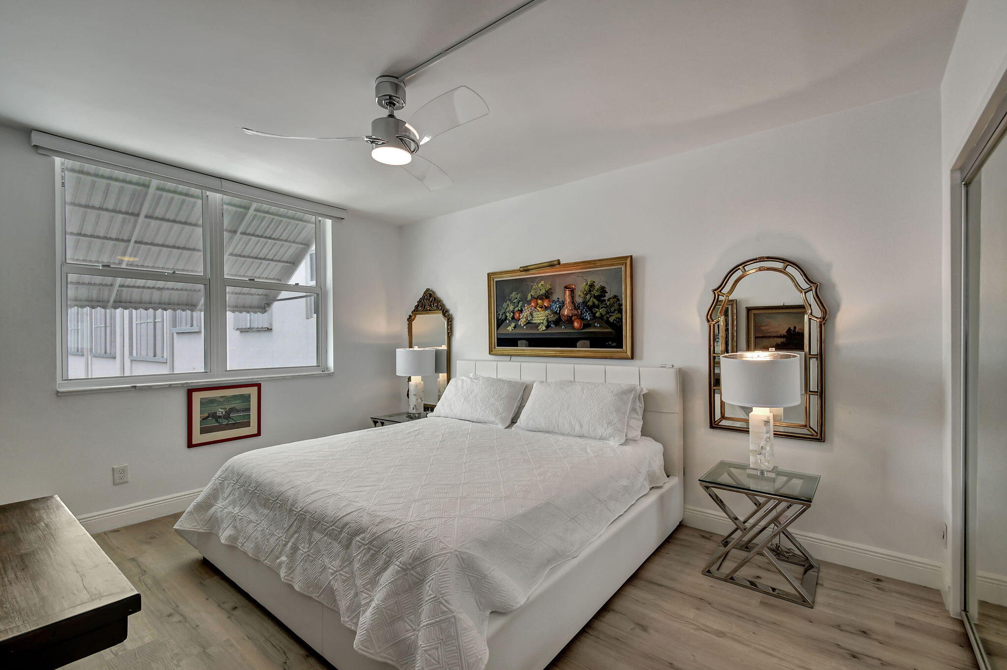 2840 South Ocean Boulevard, Unit 3020 Palm Beach, FL 33480 - Photo 17 of 40 a bedroom with a bed large mirror and a window