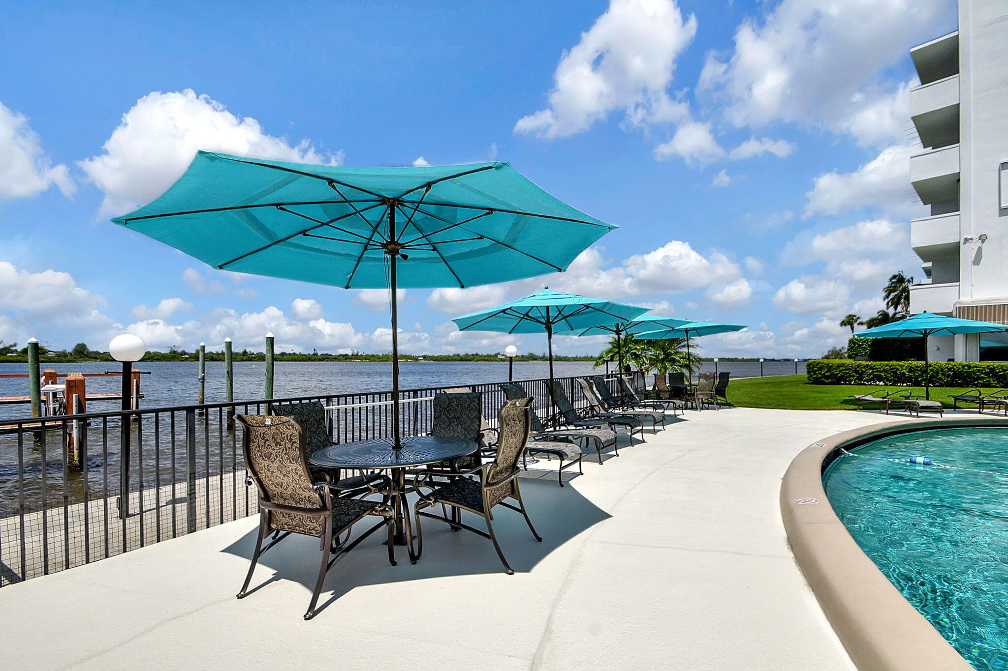 2840 South Ocean Boulevard, Unit 3020 Palm Beach, FL 33480 - Photo 25 of 40 a view of a patio with a table and chairs under an umbrella