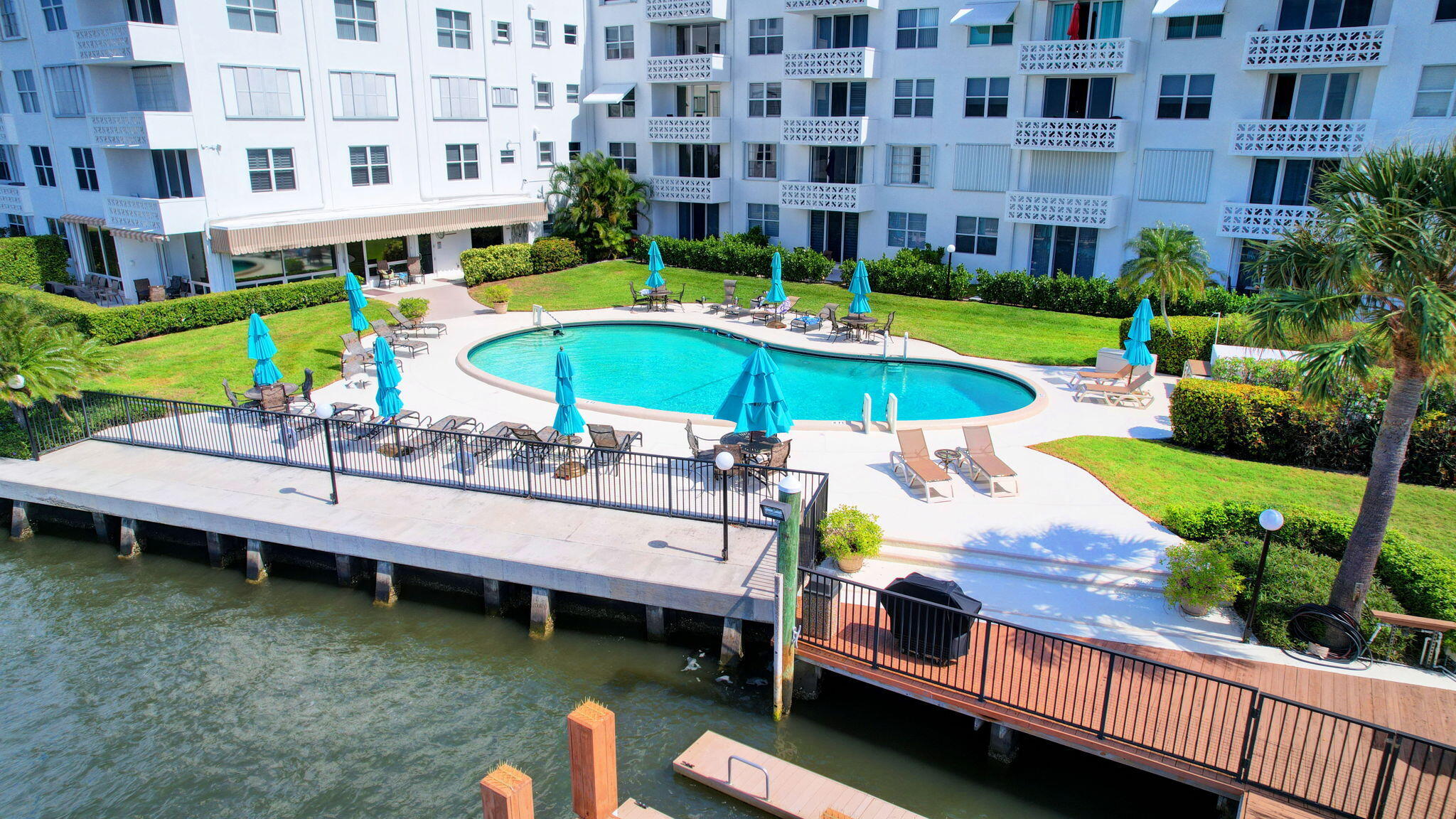 2840 South Ocean Boulevard, Unit 3020 Palm Beach, FL 33480 - Photo 28 of 40 a view of a swimming pool with a lounge chairs
