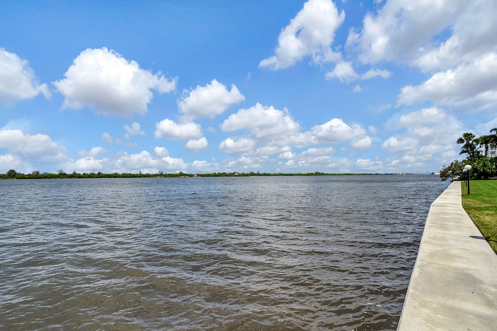 2840 South Ocean Boulevard, Unit 3020 Palm Beach, FL 33480 - Photo 3 of 40 a view of a lake from a yard