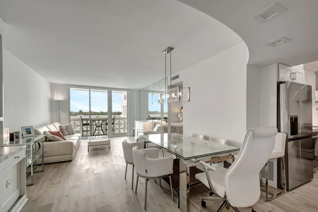 a view of a dining room with furniture wooden floor and chandelier