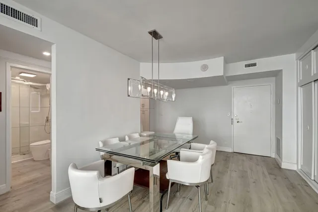 a view of a kitchen with furniture and wooden floor