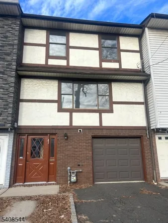 a front view of a house with a large window