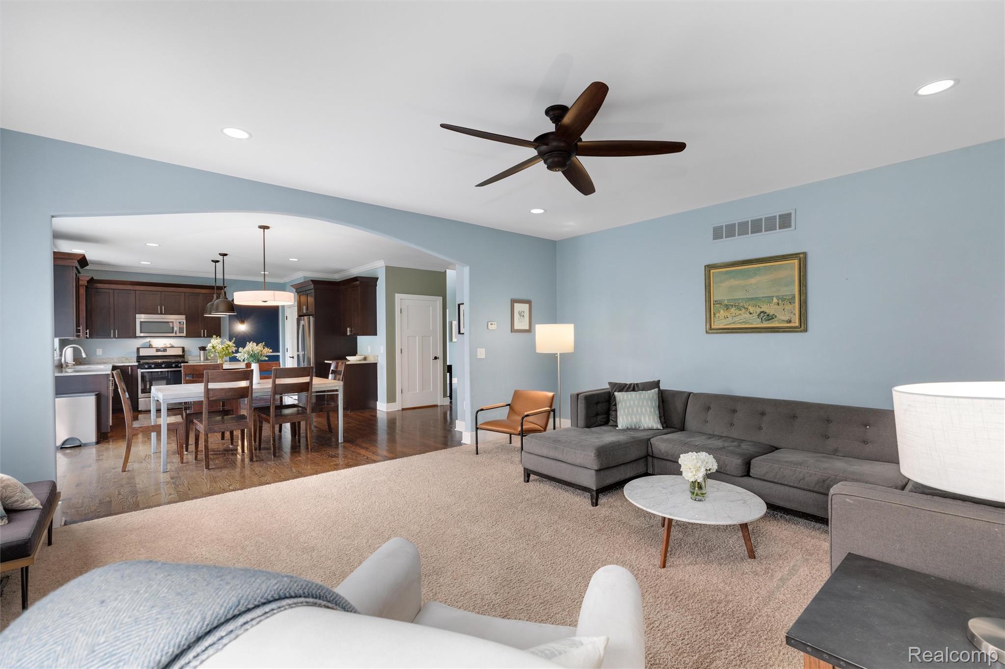 1016 West Snell Road Rochester, MI 48306 - Photo 10 of 35 Open-concept living space featuring light blue walls, recessed lighting, and a ceiling fan
