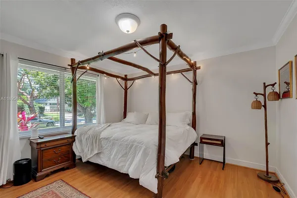 a bedroom with a bed window and a table