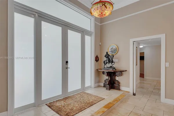 a view of a hallway to a livingroom with furniture