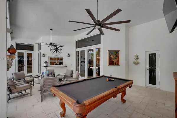 a room with pool table and flat screen tv