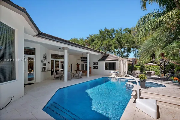 a view of a house with backyard porch and sitting area