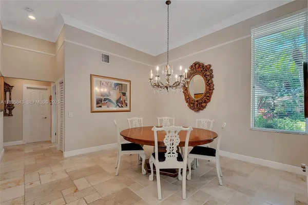 a dining room with chandelier and outdoor view